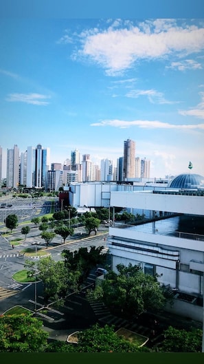 A modern urban landscape with high-rise buildings, a large dome structure, and a spacious plaza with trees and a clear sky. - Oitis Hotel (Goiania)