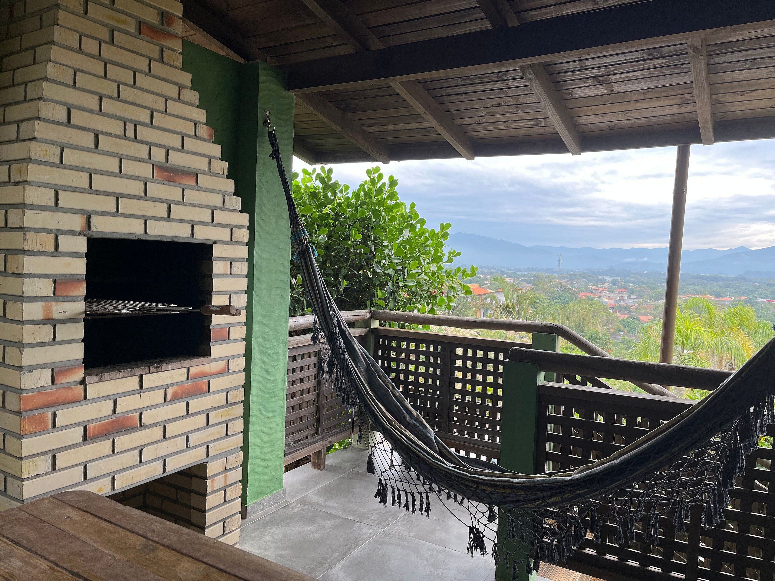 A brick oven, a hammock, and a view of a town from a balcony.
