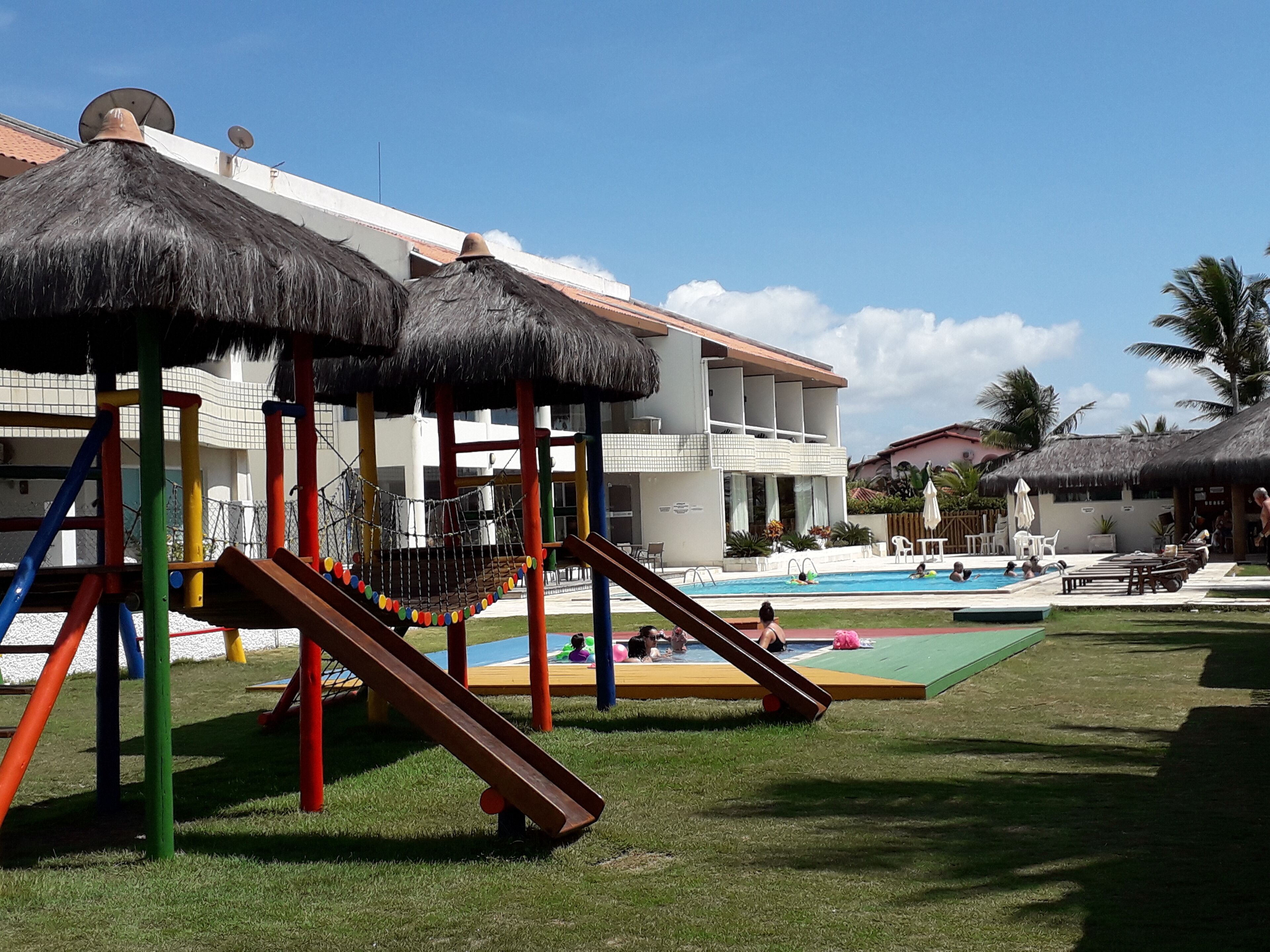 A playground with slides and a pool area.