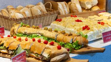A variety of sandwiches and bread displayed on a counter.