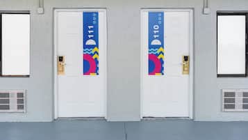Zwei weiße Türen mit farbenfrohen Mustern und den Nummern 111 und 110.