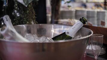 A metallic bowl filled with ice and a bottle of Salton champagne.