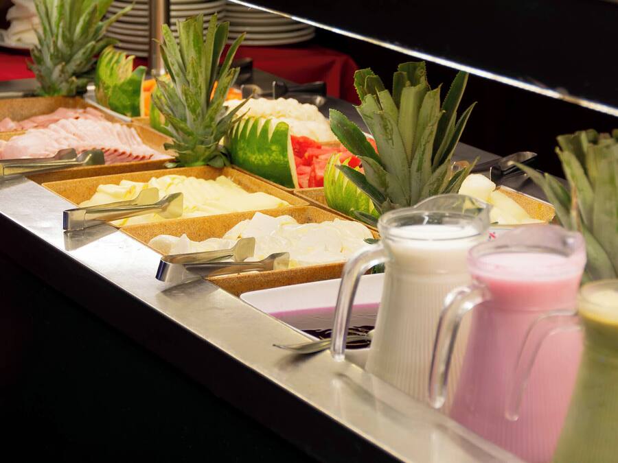 A buffet with various food items and drinks.