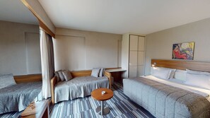 A hotel room with two beds, a small round table, and a painting on the wall. - Mimi Hotel Ankara (Ankara)
