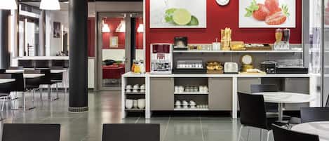 A modern cafe with tables and chairs, a coffee machine, and a wall clock.