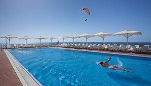 Seasonal outdoor pool, open 10 AM to 6 PM, pool umbrellas