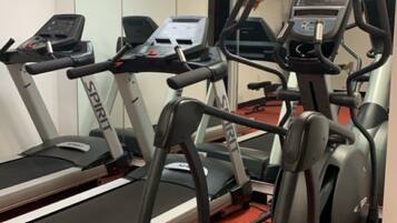 A gym with treadmills and elliptical machines.