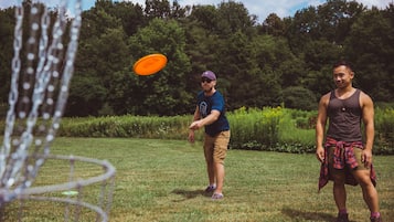 Guests can enjoy a game of frisbee in the lush green surroundings.