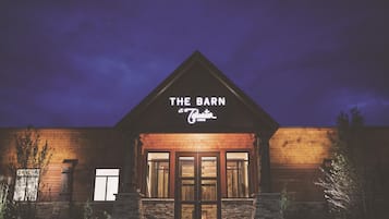 A building with a sign reading 'THE BARN at Gilwater LODGE' at night.