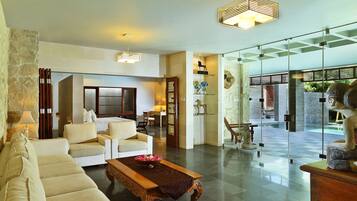 Grand Royal Two Bedroom Pool Villa | Living room | 32-inch LCD TV with cable channels, TV, books