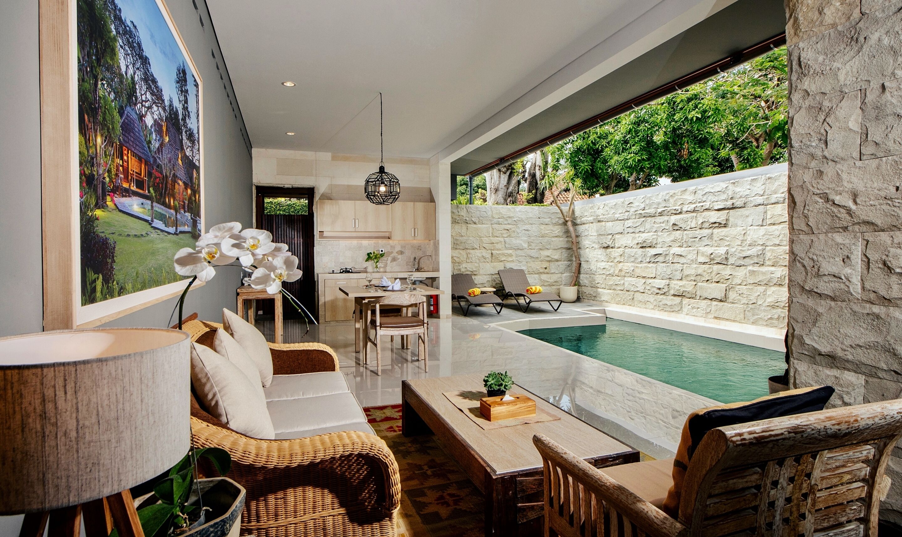 A modern living room with a dining area, a kitchen, and a pool.