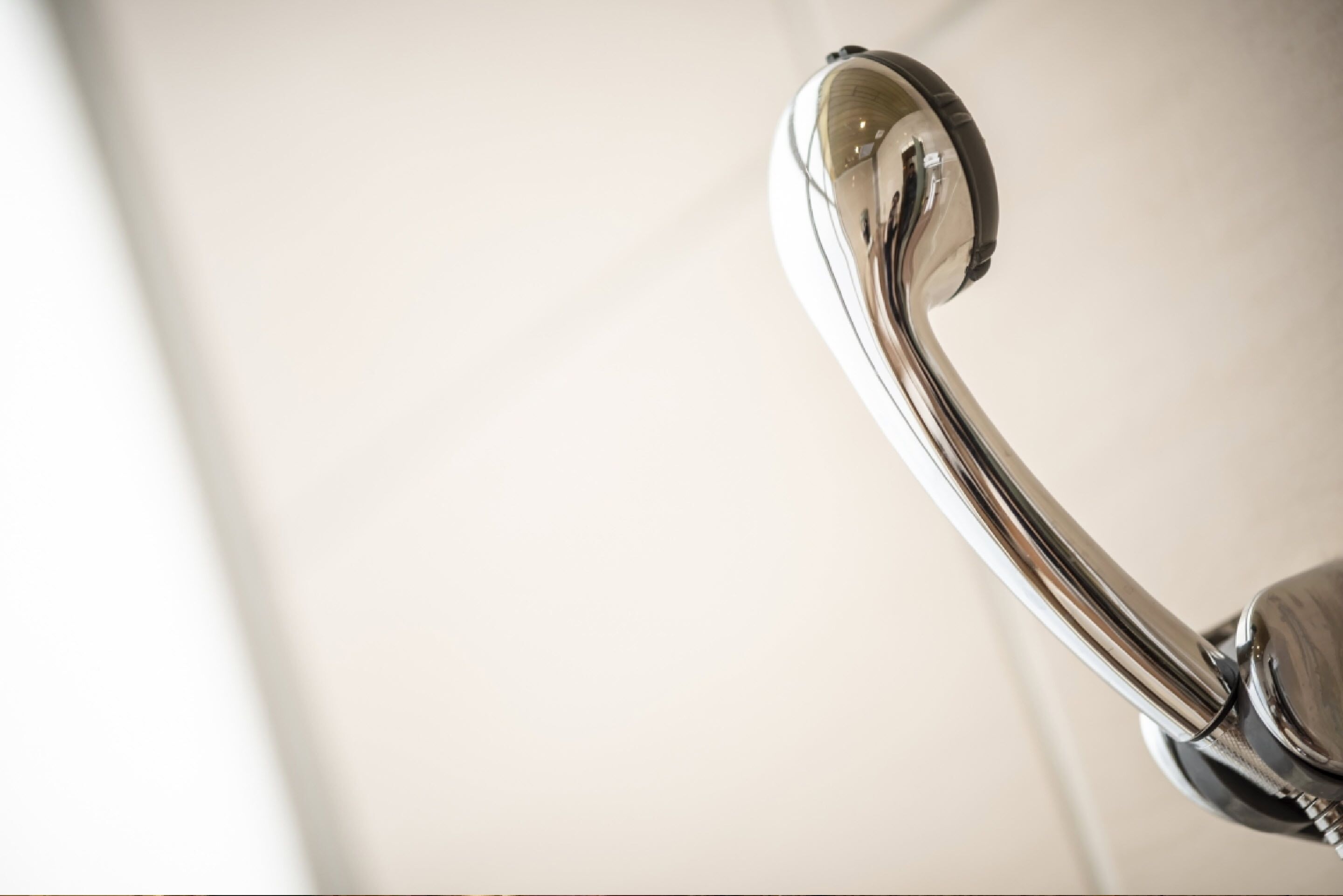 A chrome faucet with a curved spout.