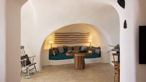 A cozy seating area with a sofa, a wooden coffee table, and a lamp.