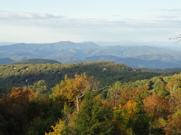 A mountainous landscape with dense forest and scattered buildings.