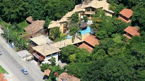 Vista aérea de una zona residencial con varias casas rodeadas de abundante vegetación.