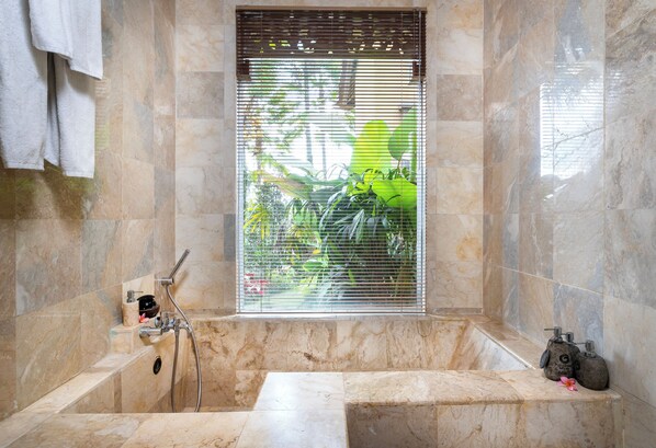 A bathroom with a marble tub, a window with blinds, and a shower. - Puri Gangga Resort Ubud (Sebatu)