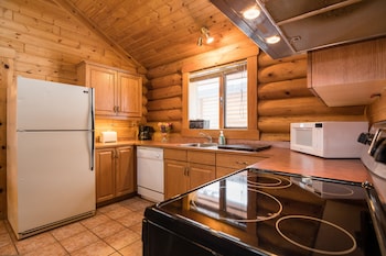 Deluxe Chalet, 1 Bedroom | Private kitchen | Fridge, microwave, oven, coffee/tea maker at Castle Mountain Chalets