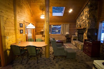Deluxe Chalet, 1 Bedroom | Living room | Flat-screen TV, fireplace, DVD player, iPod dock at Castle Mountain Chalets