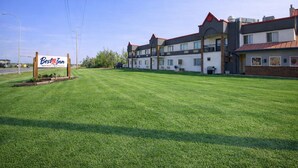 Hyvin hoidettu Best Western -hotelli, jossa on siisti nurmikko ja useita kerroksia sisältäviä rakennuksia.