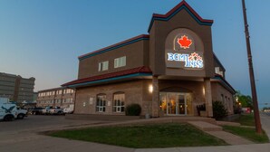 A building with a prominent 'B.C. Inns' sign featuring a red maple leaf logo. - BCMInns Fort McMurray (Fort McMurray)