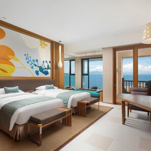 A hotel room with two beds, a dining table, and a view of the sea. - Regal Palace Resort (Huizhou)