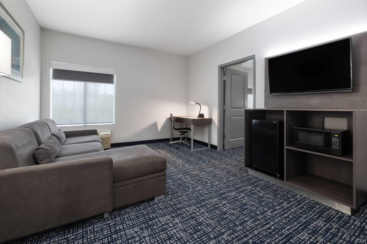 suite, 1 king bed with sofa bed, non smoking (two room) | premium bedding, desk, iron/ironing board, free cots/infant beds