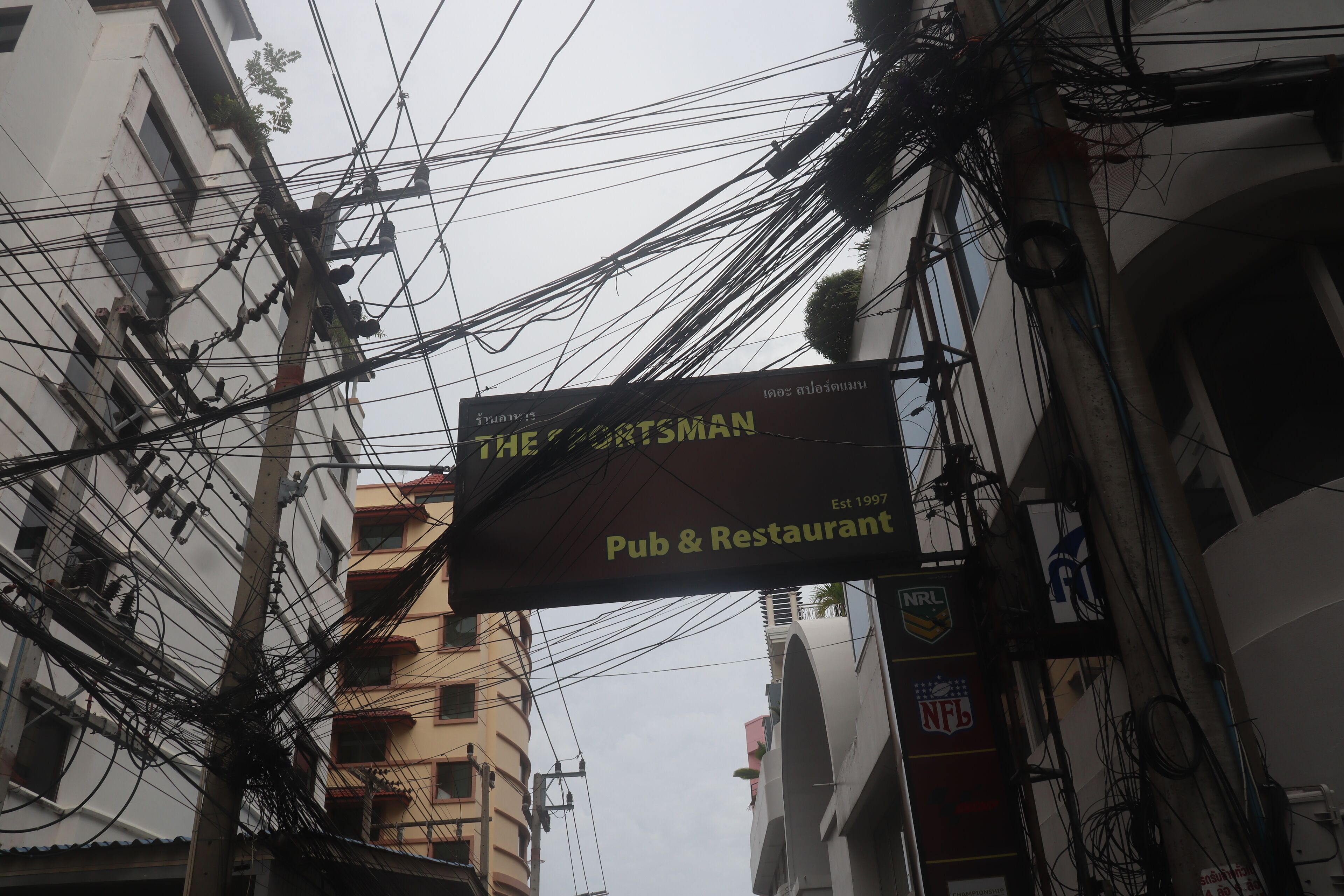 Ein Schild für 'The Craftsman Pub & Restaurant' mit sichtbaren Logos für NRL und NFL, das die Zugehörigkeit des Etablissements zu Sportteams kennzeichnet.
