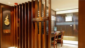 A modern interior with a wooden partition labeled "INTERNET ROOM," a desk with a computer, and a chair. - Inn House Hotel (Pattaya)