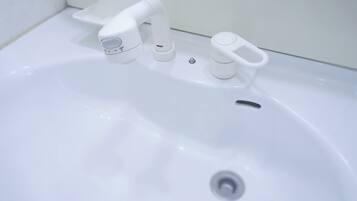 Shower, hair dryer, slippers, towels