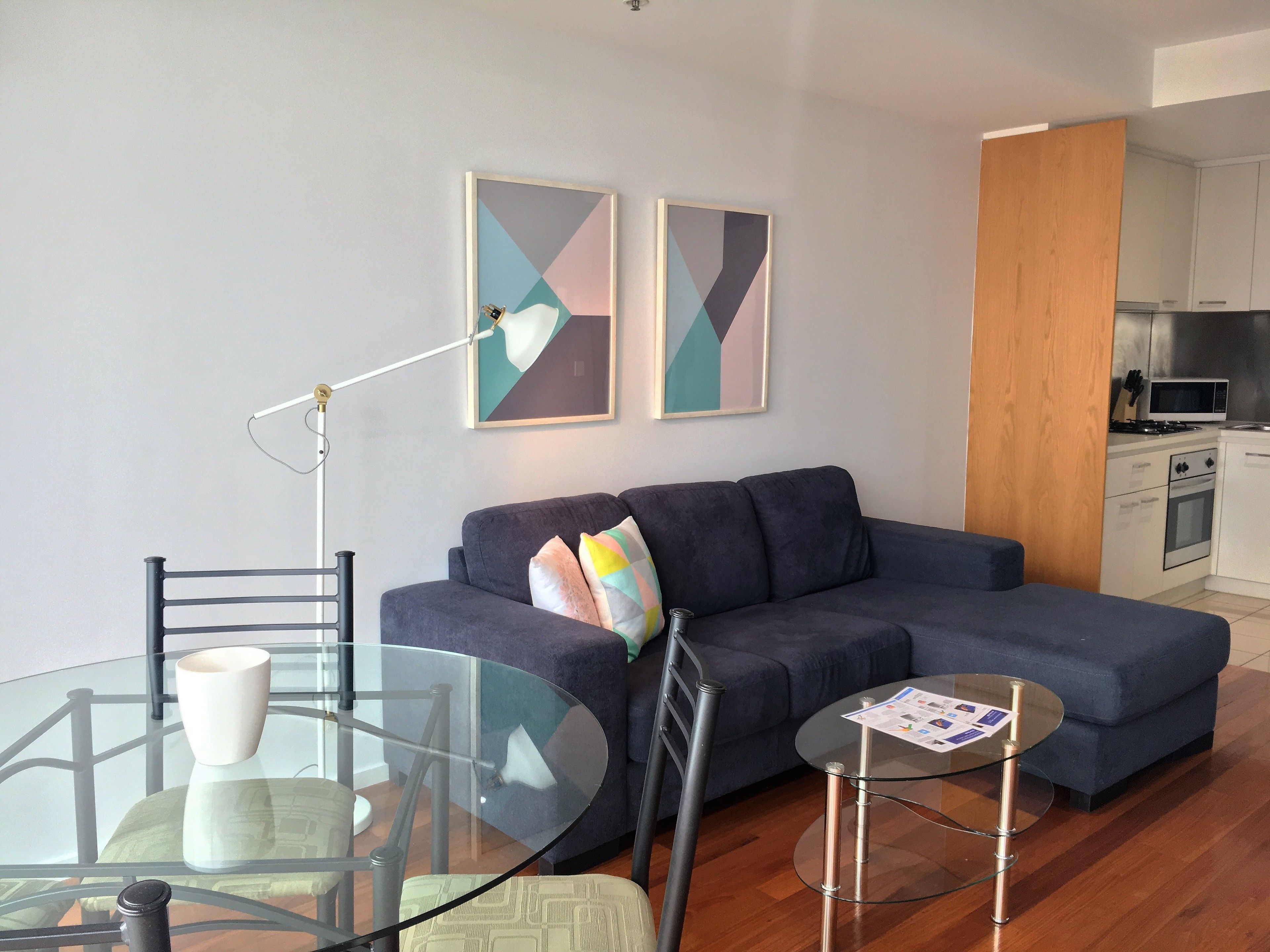 Deluxe One Bedroom Apartment - Melbourne Star View | Living area | 32-inch LCD TV with cable channels, TV, DVD player
