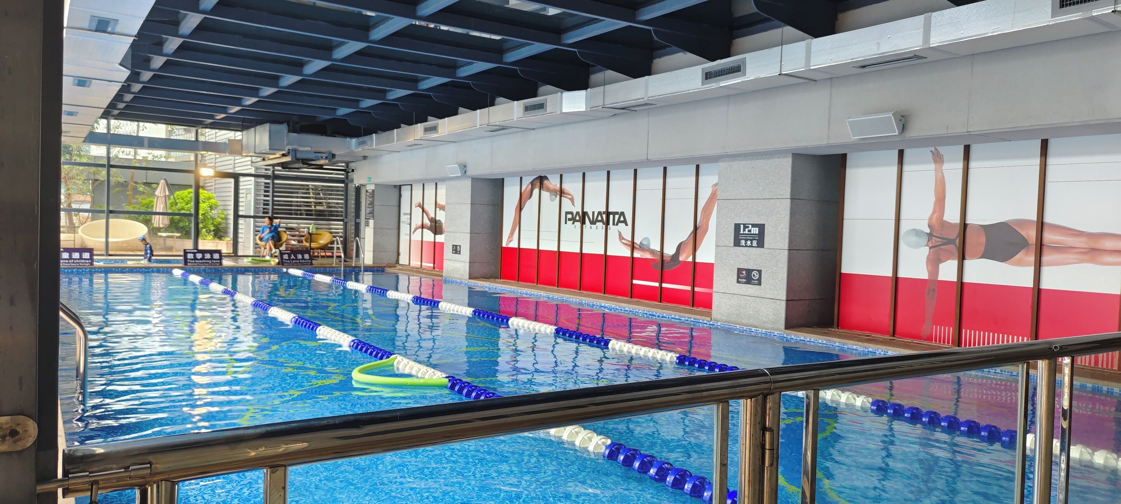 Una piscina interior con separadores de carril y un puesto de socorrista.