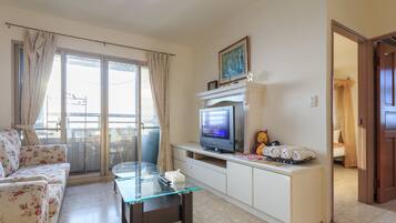 Family Room, 2 Double Beds (Deluxe) | Living area | 32-inch LCD TV with cable channels, TV