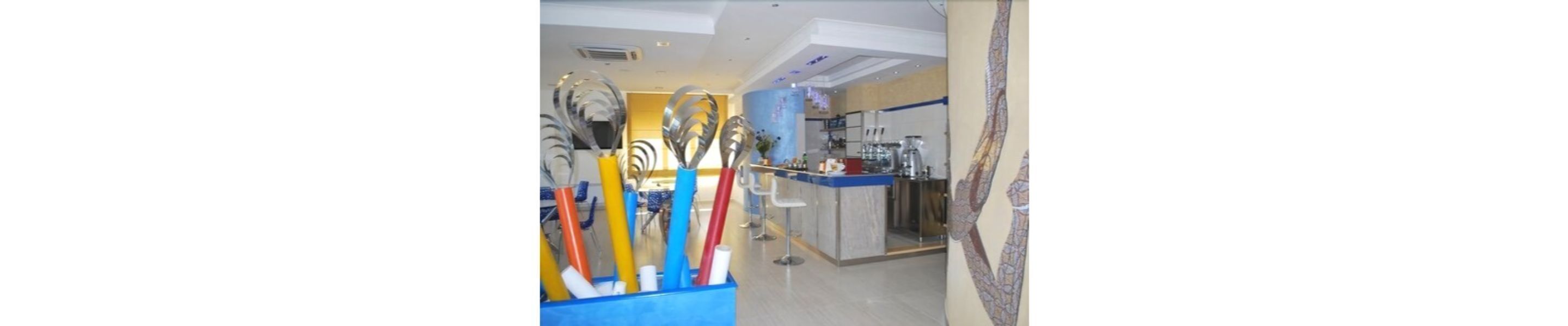 A kitchen area with a bar counter, a sink, and various kitchen utensils.