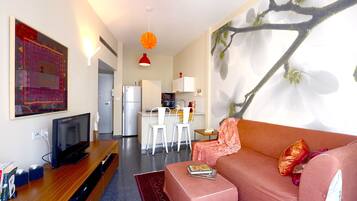 Design Apartment | Living room | 39-inch flat-screen TV with cable channels, LCD TV, DVD player