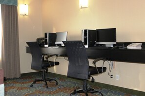 A hotel room with a desk, two chairs, a computer, a phone, and a lamp. - Holiday Inn Express Yorkton East by IHG (Yorkton)