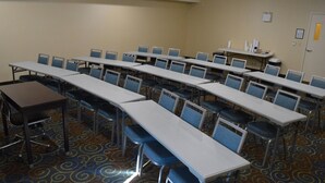 A conference room with multiple tables and chairs, carpeted floor, and a whiteboard on the wall. - Holiday Inn Express Yorkton East by IHG (Yorkton)