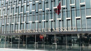 A modern building facade with a grid of windows and a sign reading 'ATATURK KULTUR MERKEZI'.