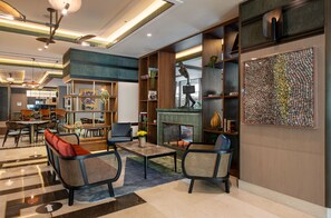 A modern lobby with a fireplace, seating area, and a large abstract art piece. - The Artisan Hotel Istanbul - MGallery Collection (Istanbul)
