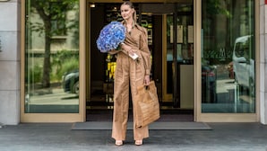 A woman in beige attire exiting a building labeled "The Artisan Istanbul."