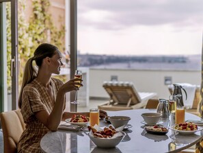 A dining table with breakfast items and a glass of orange juice. - The Artisan Hotel Istanbul - MGallery Collection (Istanbul)