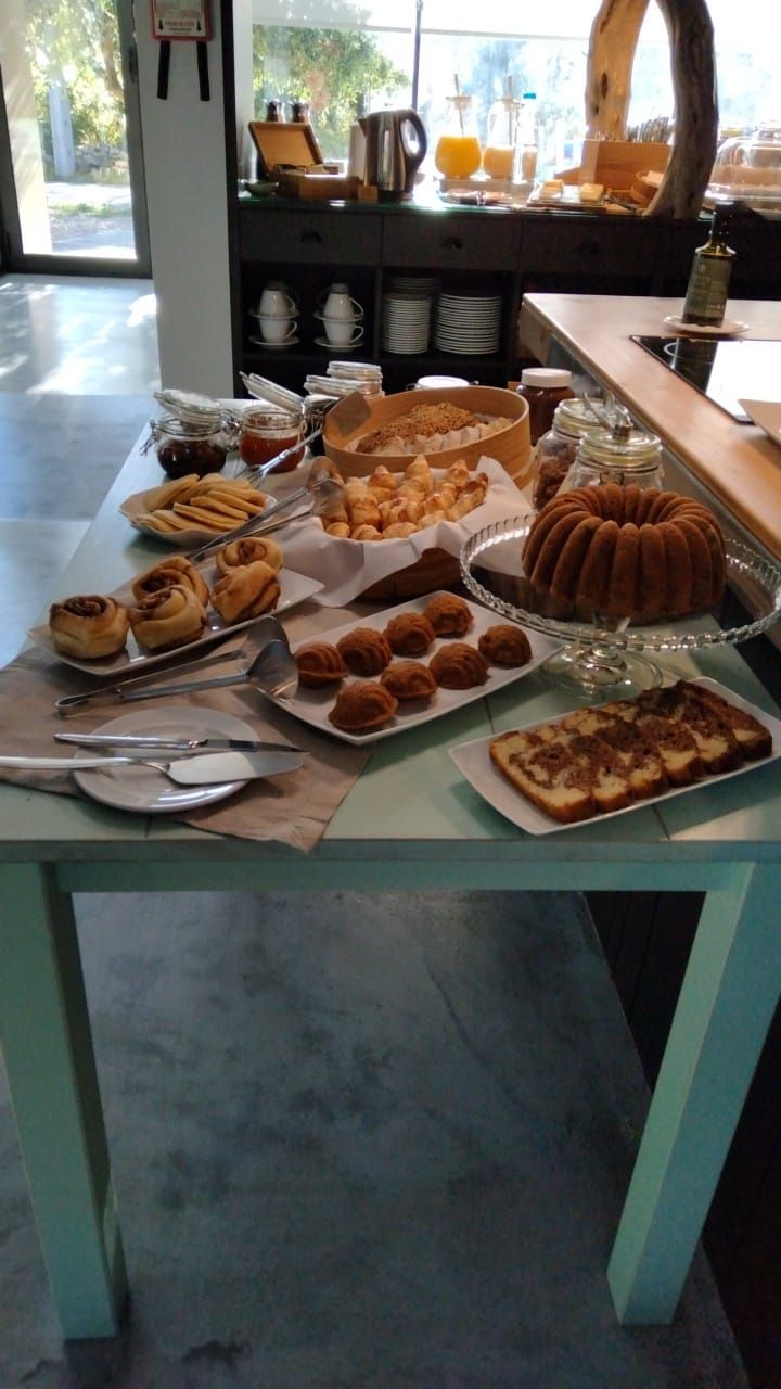 A buffet table with various baked goods and a coffee station.