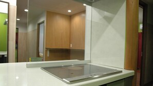 A kitchenette with a built-in stove, a microwave, and a sink.