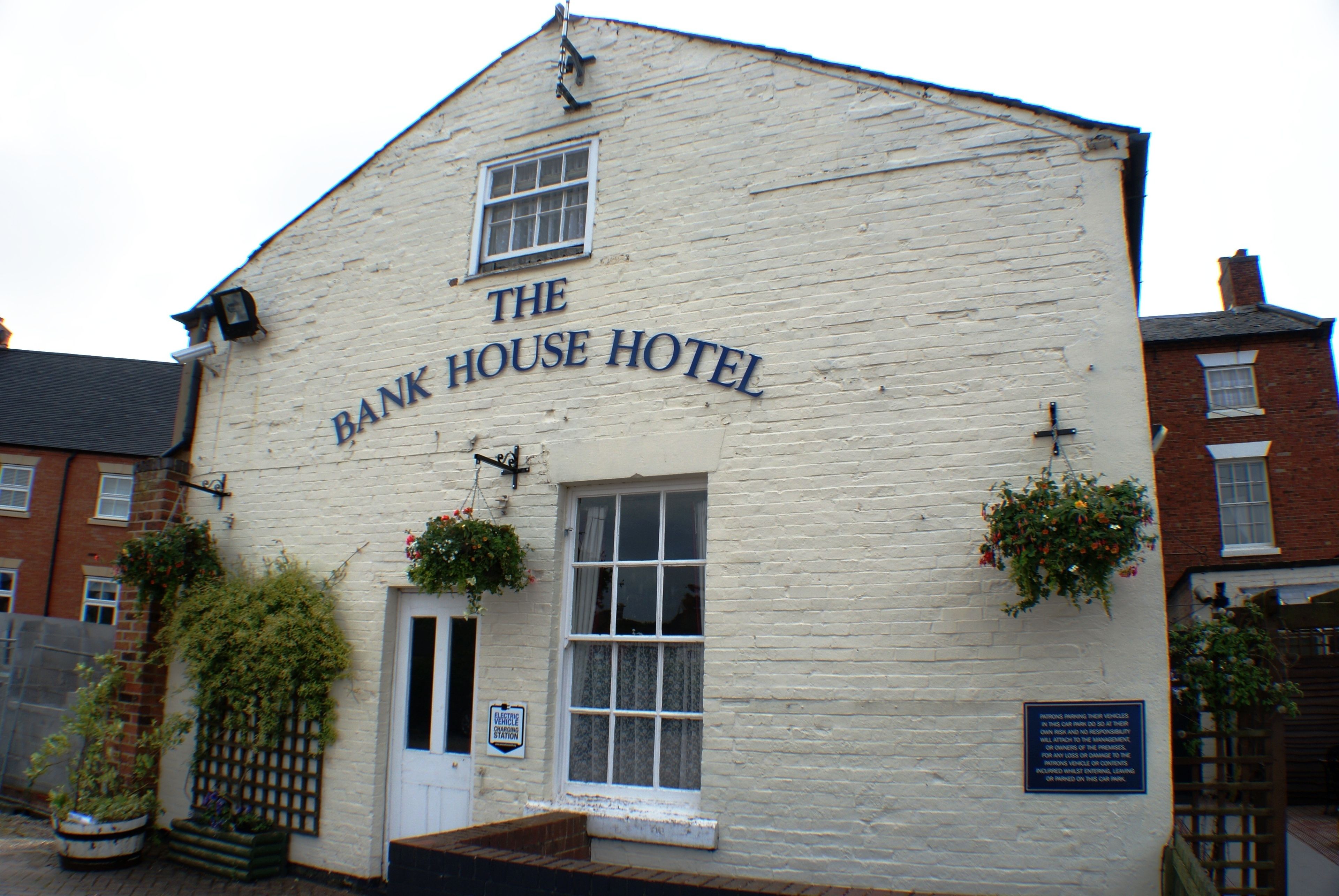 A white building with the sign "The Bank House Hotel" on the front.