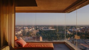 A high-rise room with a large window overlooking a cityscape. - Dar Hi (Nefta)