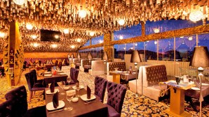 A luxurious dining area with high ceilings, multiple tables, and comfortable seating. - Teatro Boutique Hotel (Baku)