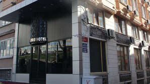 A hotel with a modern facade, multiple balconies, and a prominent entrance with a red carpet. - Kaya Madrid Hotel (Istanbul)
