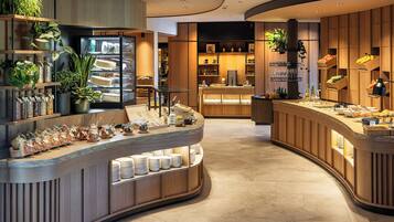 A modern breakfast bar with a curved design, featuring a variety of food items and condiments.