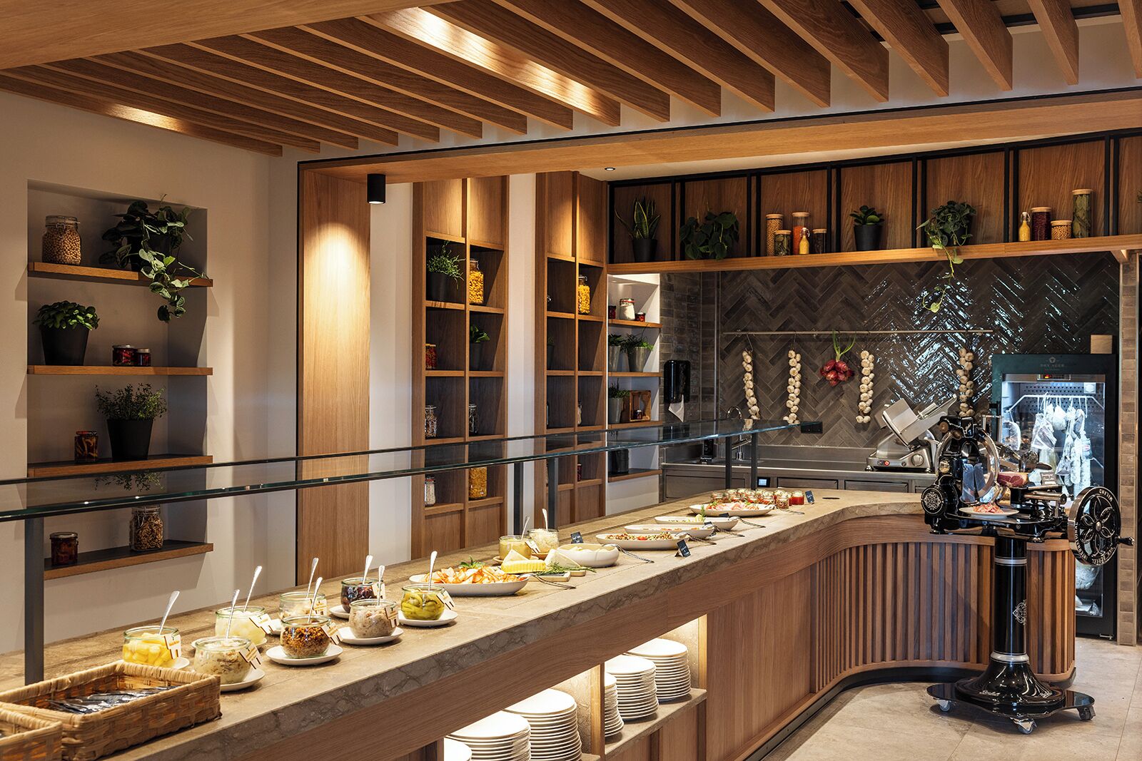 A buffet setup with various food items and a coffee machine.