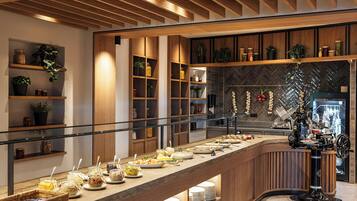 A buffet setup with various food items and a coffee machine.