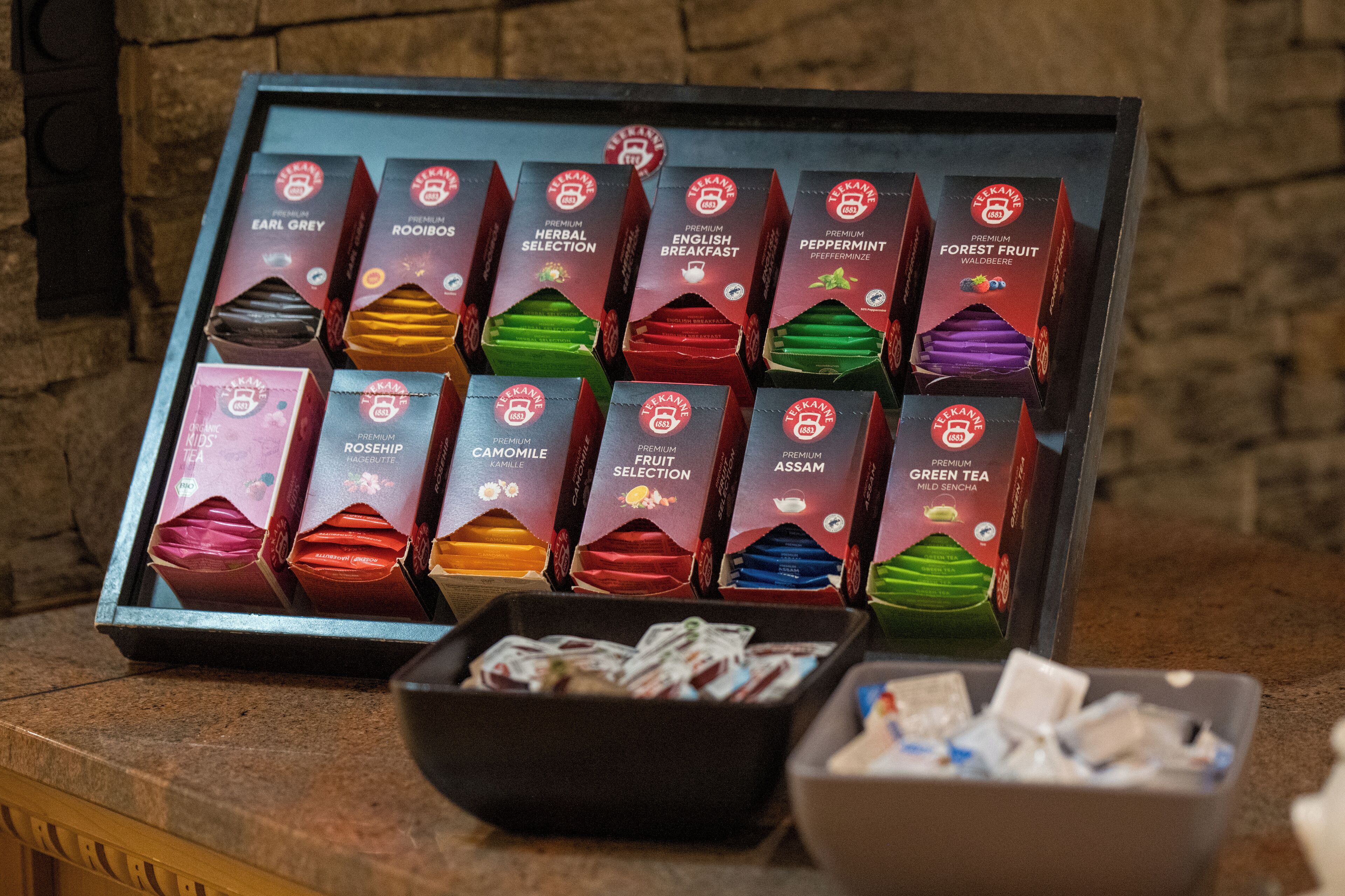 A display of tea boxes with various flavors such as Earl Grey, Rooibos, and Green Tea.